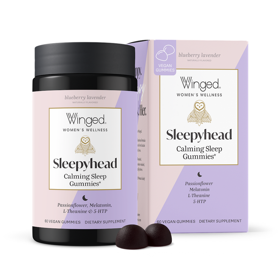 A package of Sleepyhead Calming Sleep Gummies by Winged Wellness, with two gummies in front of the box and an unboxed package of Sleepyhead. The box is purple and pink with product information and branding.